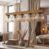 Holzbalken-Pendelleuchte Koyoto mit 5 geriffelten Glas-Kugelschirmen in Bernstein